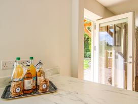 A kitchen with drinks and cookies on a tray at Hoddell Pitch Cottage in Kinnerton near New Radnor