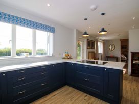 A kitchen with counter space and windows at Hoddell Pitch Cottage Kinnerton near New Radnor