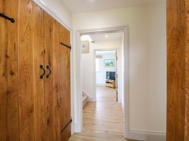 A hallway with wooden doors and a view of a living area at Hoddell Pitch Cottage Kinnerton near New Radnor