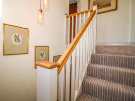 A staircase with pictures on the wall at Hoddell Pitch Cottage Kinnerton near New Radnor