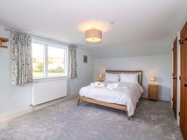 A bedroom with a bed and nightstand at Hoddell Pitch Cottage Kinnerton near New Radnor