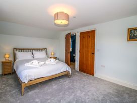 A bedroom with a bed and bedside table at Hoddell Pitch Cottage in Kinnerton near New Radnor