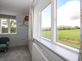 A bedroom with a view and furniture at Hoddell Pitch Cottage, Kinnerton near New Radnor