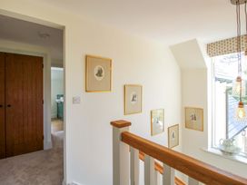 A hallway with framed pictures on the wall at Hoddell Pitch Cottage in Kinnerton near New Radnor