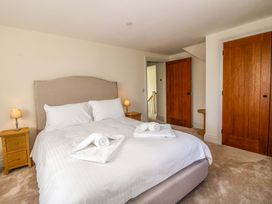 A bedroom with a bed and bedside tables at Hoddell Pitch Cottage Kinnerton near New Radnor