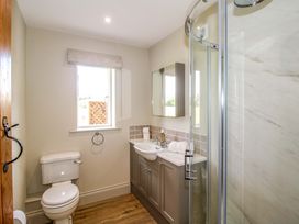 A bathroom with a sink and shower at Hoddell Pitch Cottage Kinnerton near New Radnor