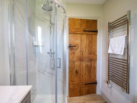 A bathroom with a shower and towel rail at Hoddell Pitch Cottage in Kinnerton near New Radnor