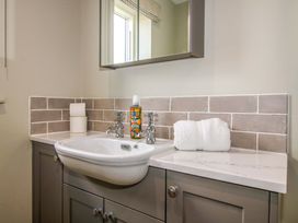 A bathroom with a sink and mirror at Hoddell Pitch Cottage Kinnerton near New Radnor