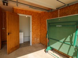 A garage with a table tennis table and a door at Hoddell Pitch Cottage Kinnerton near New Radnor