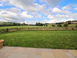 A grassy field with a fence and gate at Hoddell Pitch Cottage Kinnerton near New Radnor