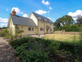 A house with a garden and fence at Hoddell Pitch Cottage Kinnerton near New Radnor
