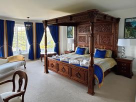 A bedroom with a four-poster bed and furniture at Bayview Tower in Lynton