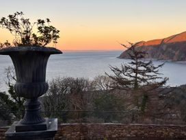 An outdoor area with a planter overlooking the ocean at Bayview Tower in Lynton