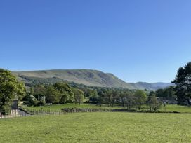 A view of mountains and fields at Winn's Cottage in Pooley Bridge
