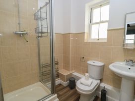 A bathroom with a shower, toilet, and sink at Weyside in Weymouth