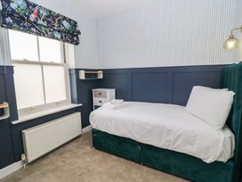 A bedroom with a single bed and window at Weyside in Weymouth