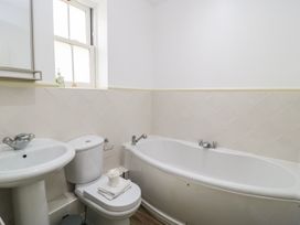A bathroom with a bathtub, sink, and toilet at Weyside in Weymouth