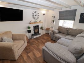 A living room with a television and sofa at 41 St. James Street, Narberth