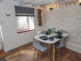 A dining room with a table set for meals at 41 St. James Street Narberth