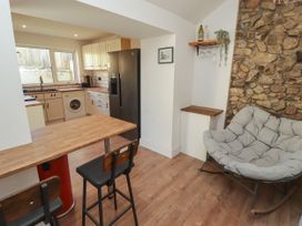 A kitchen with appliances and a table at 41 St. James Street in Narberth