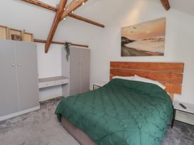 A bedroom with a bed and wardrobes at 41 St. James Street Narberth