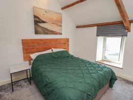 A bedroom with a bed and bedside table at 41 St. James Street in Narberth