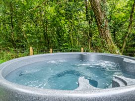 A hot tub filled with water in an outdoor space at Bodior Lodge Rhoscolyn