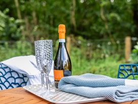 An outdoor setting with prosecco and glasses on a tray at Bodior Lodge in Rhoscolyn