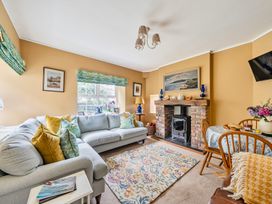 A living room with a fireplace and seating area at Bodior Lodge in Rhoscolyn