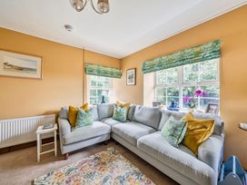A living room with a sofa and table at Bodior Lodge Rhoscolyn