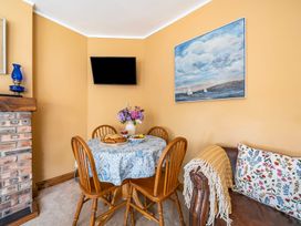 A dining room with a table and chairs at Bodior Lodge Rhoscolyn