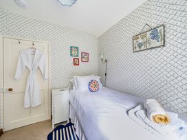 A bedroom with a bed and decorative items at Bodior Lodge in Rhoscolyn