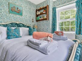 A bedroom with a bed and decorative pillows at Bodior Lodge in Rhoscolyn
