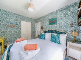 A bedroom with a bed and decor at Bodior Lodge Rhoscolyn