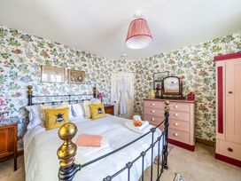 A bedroom with a bed and dressing table at Bodior Lodge in Rhoscolyn