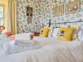 A bedroom with a bed and pillows at Bodior Lodge in Rhoscolyn