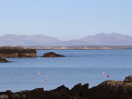 A coastal scene with rocks and water at Bodior Garden Cottage in Rhoscolyn