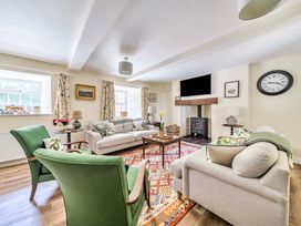 A living room with a sofa and armchairs at Bodior Garden Cottage in Rhoscolyn