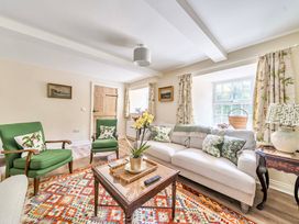 A living room with a sofa and armchairs at Bodior Garden Cottage in Rhoscolyn