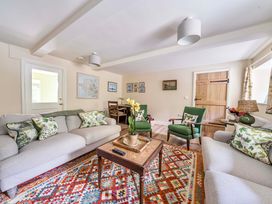 A living room with a sofa and armchairs at Bodior Garden Cottage in Rhoscolyn