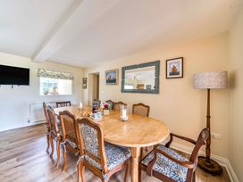 A dining room with a table and chairs at Bodior Garden Cottage Rhoscolyn