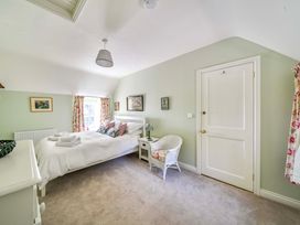 A bedroom with a bed and bedside table at Bodior Garden Cottage Rhoscolyn