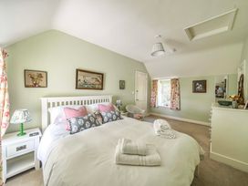 A bedroom with a bed and bedside table at Bodior Garden Cottage in Rhoscolyn