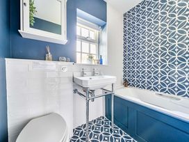 A bathroom with a sink and bathtub at Bodior Garden Cottage Rhoscolyn