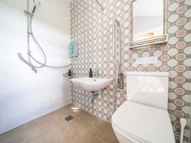 A bathroom with a shower, sink, and toilet at Bodior Garden Cottage in Rhoscolyn