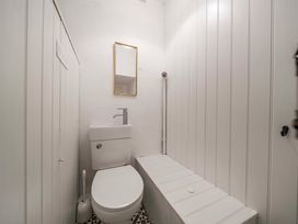 A bathroom with a toilet and sink in Bodior Garden Cottage Rhoscolyn
