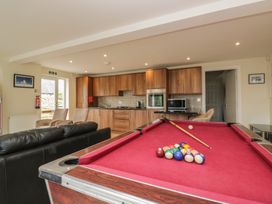 A game room featuring a pool table and kitchen area at Whimhowe Windermere