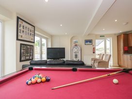 A snug with a pool table and television at Whimhowe in Windermere