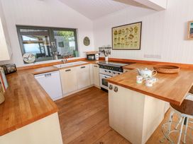 A kitchen with a sink and stove at Green Shutters in Freshwater East near Lamphey