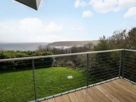 A view of the ocean and green area from a balcony at Green Shutters Freshwater East near Lamphey
